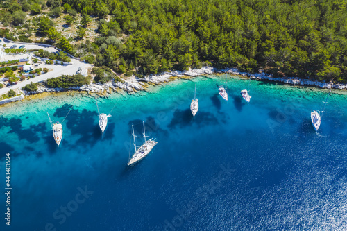 Aerial photo of sailing boats docked in blue bay of Fiskardo  Kefalonia island  Ionian  Greece