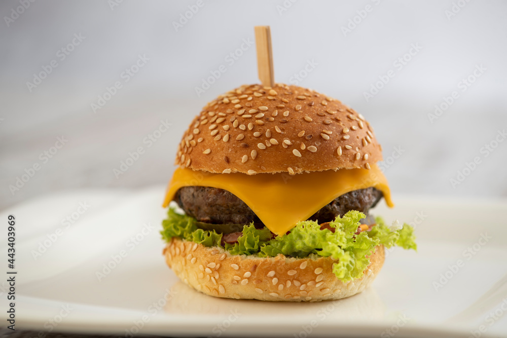mini burger with cheese and lettuce with sticks - obrazy, fototapety, plakaty 