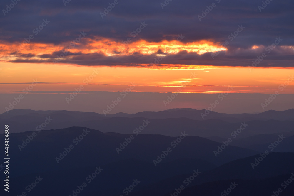 Beautiful landscape background, clouds over mountains before sunrise