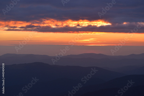 Beautiful landscape background, clouds over mountains before sunrise © Ihor