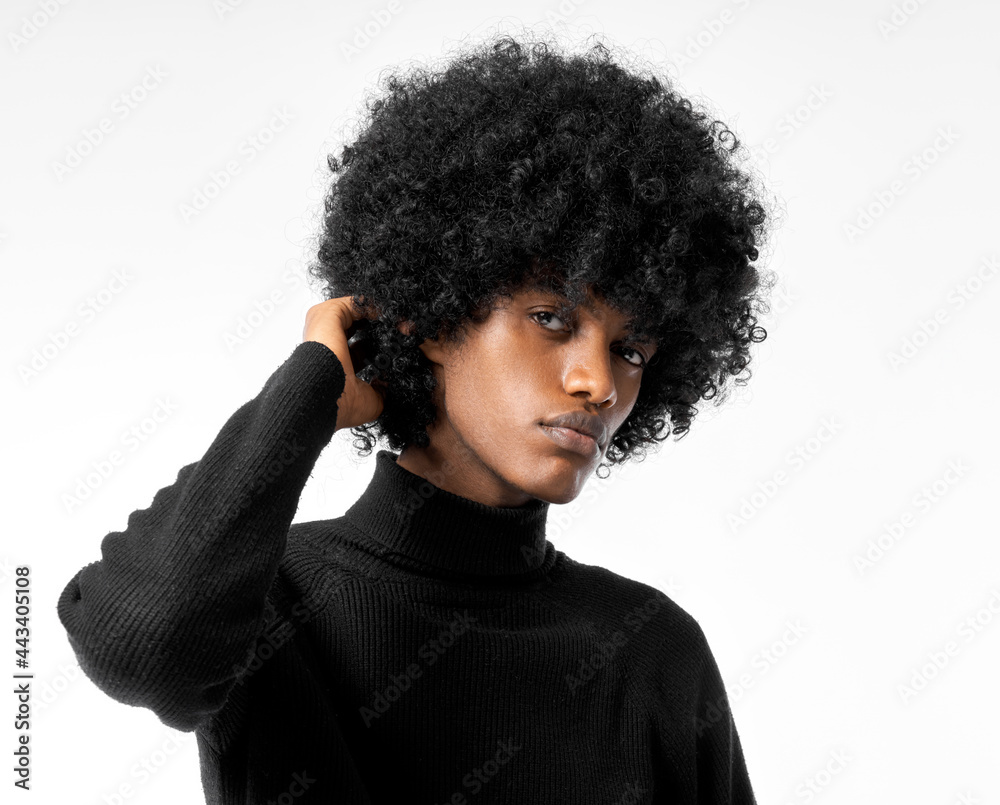 Portrait of young handsome black man touching his afro hair isolated on white background Portrait of young handsome black man touching his afro hair isolated on white background