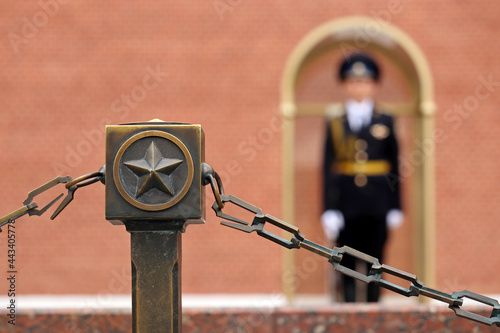 Soviet star and defocused view to russian soldier on duty near the Kremlin wall. The honor guard of the Presidential regiment of Russia