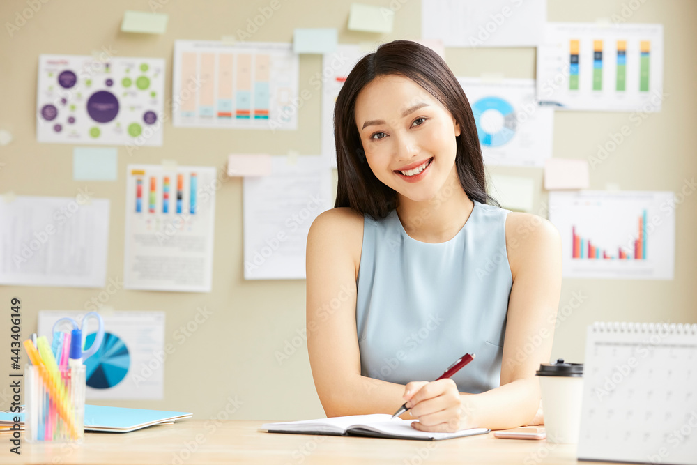 Portrait of beautiful business woman is happy smiling while working in the office Portrait of beautiful business woman is happy smiling while working in the office