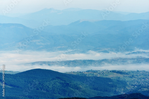 Beautiful landscape background  alpine valley village in cold fog