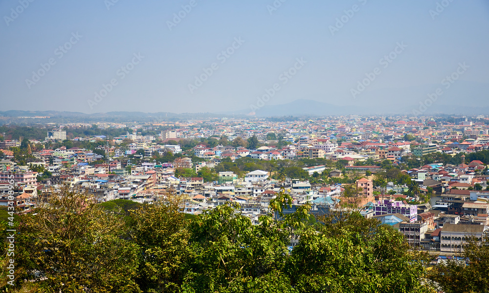 Fototapeta premium View from the hill of the Thai town of Mae Sai to the border town of Tachilek in Myanmar. view of the Thai Burmese border. Chiang Rai Province. North of Thailand