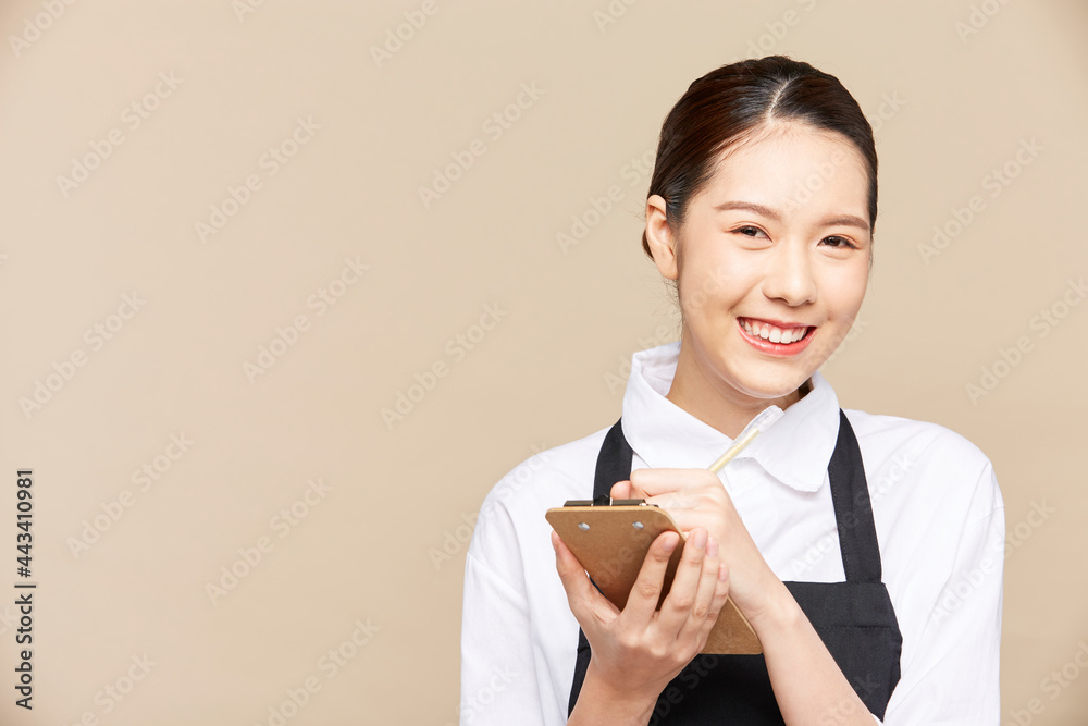 Portrait of asian female beautiful waitress is taking order with happy smiling at isolate blank empty background studio Portrait of asian female beautiful waitress is taking order with happy smiling at isolate blank empty background studio