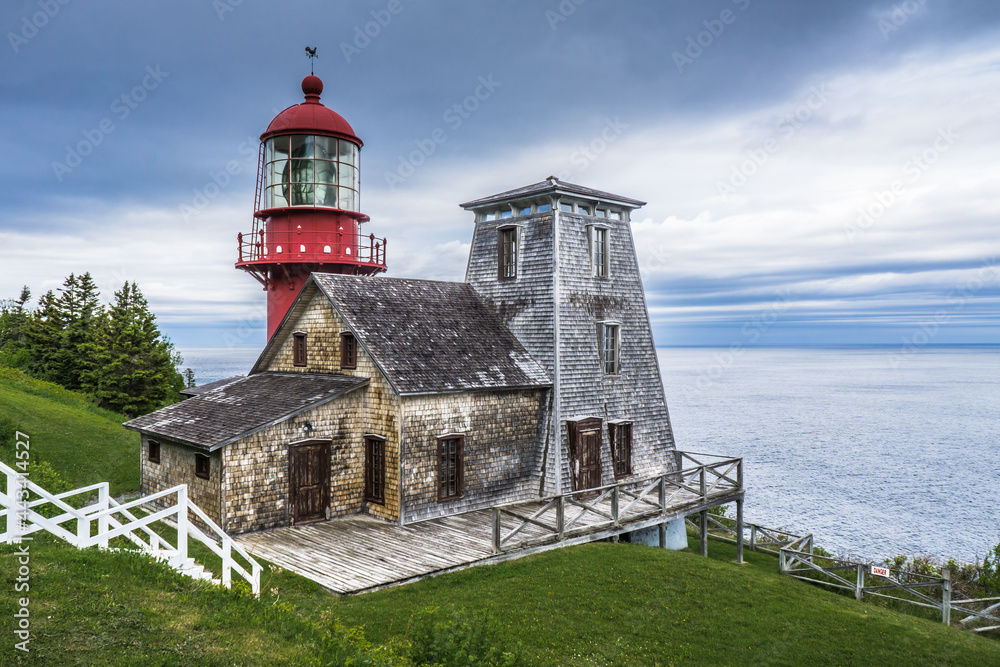 View on the beautiful Pointe a la Renommée Lighthouse covered with shingles, one of the most famous lighthouse of Gaspesie, in Quebec (Canada)
