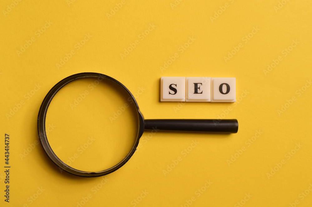 Magnifying glass and square letters with text SEO stands for Search Engine Optimization Stock Photo | Adobe Stock