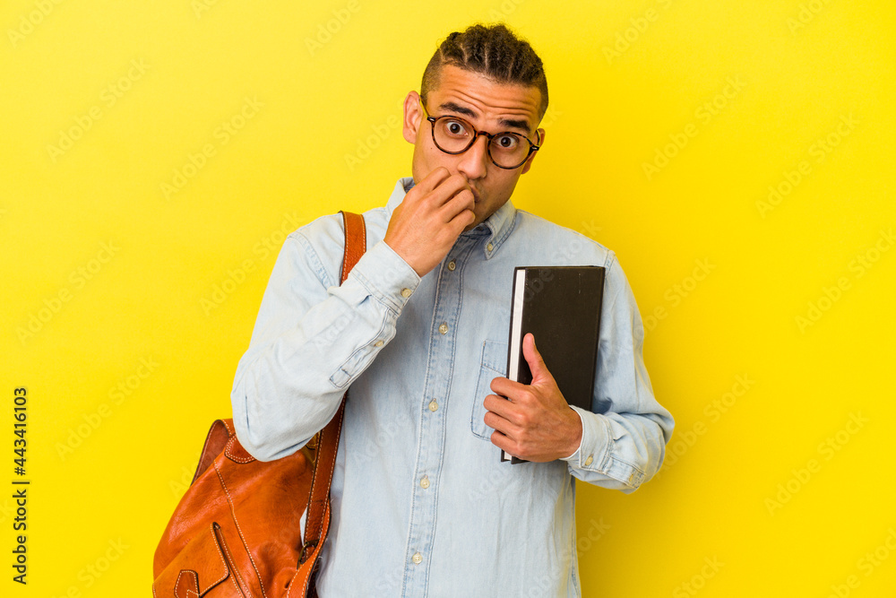 Young venezuelan student man isolated on yellow background biting fingernails, nervous and very anxious. Young venezuelan student man isolated on yellow background biting fingernails, nervous and very anxious.