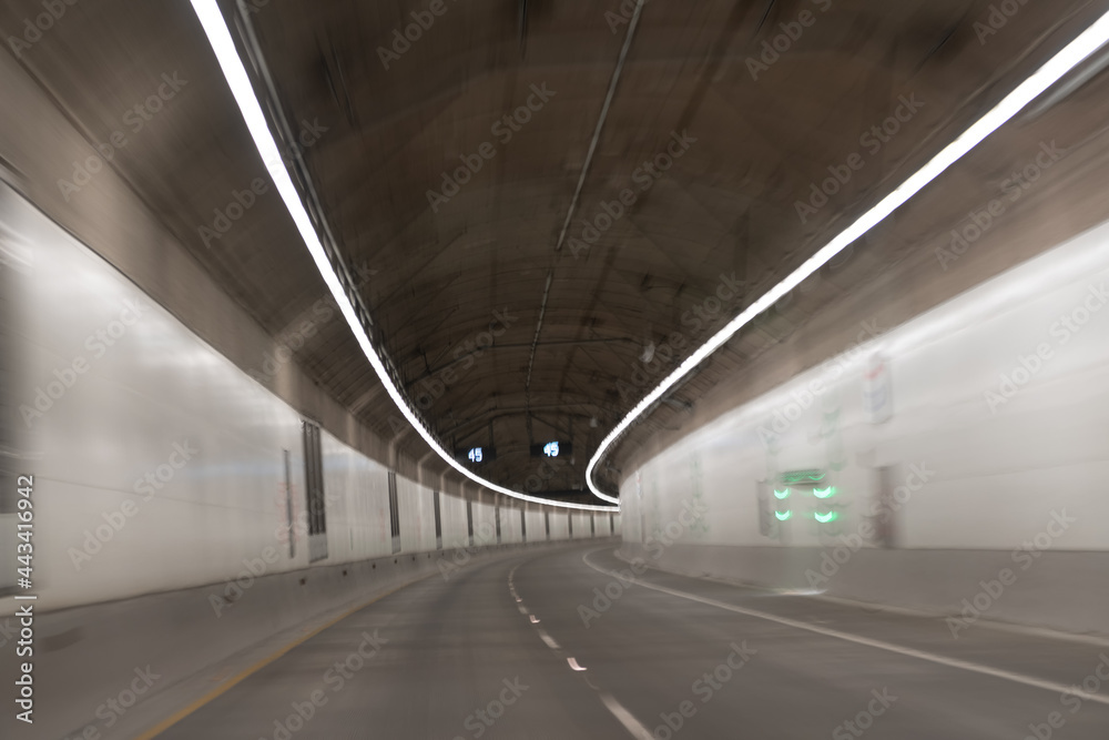 motion car go through illuminated way under ground. light trails. transportation background.