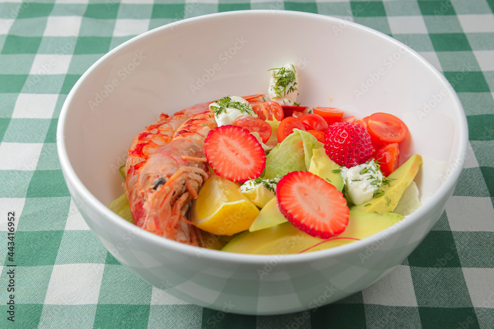Fresh shrimp and berry salad with lettuce. Salad made from shrimps. cream cheese, avocado, cherry tomatoes, strawberry. Fresh shrimp and berry salad with lettuce. Salad made from shrimps. cream cheese, avocado, cherry tomatoes, strawberry.