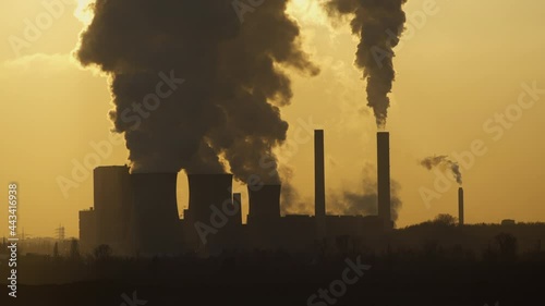 steam rising from the cooling tower of a lignite-fired power plant photo