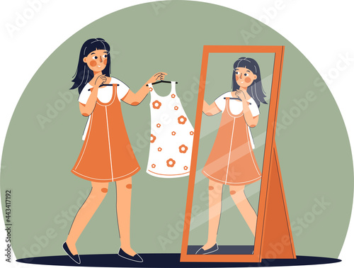 Girl trying on dress in clothing store. Shopping. Woman buys a fashionable, beautiful dress.
