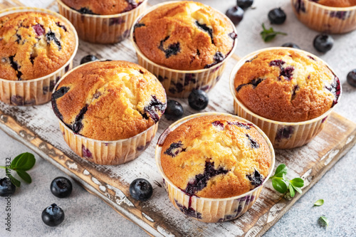 Homemade vegan blueberry muffins on white background.