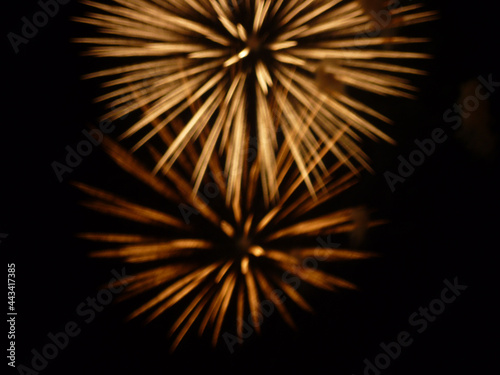 Festive fireworks in the black night sky blurred no focus