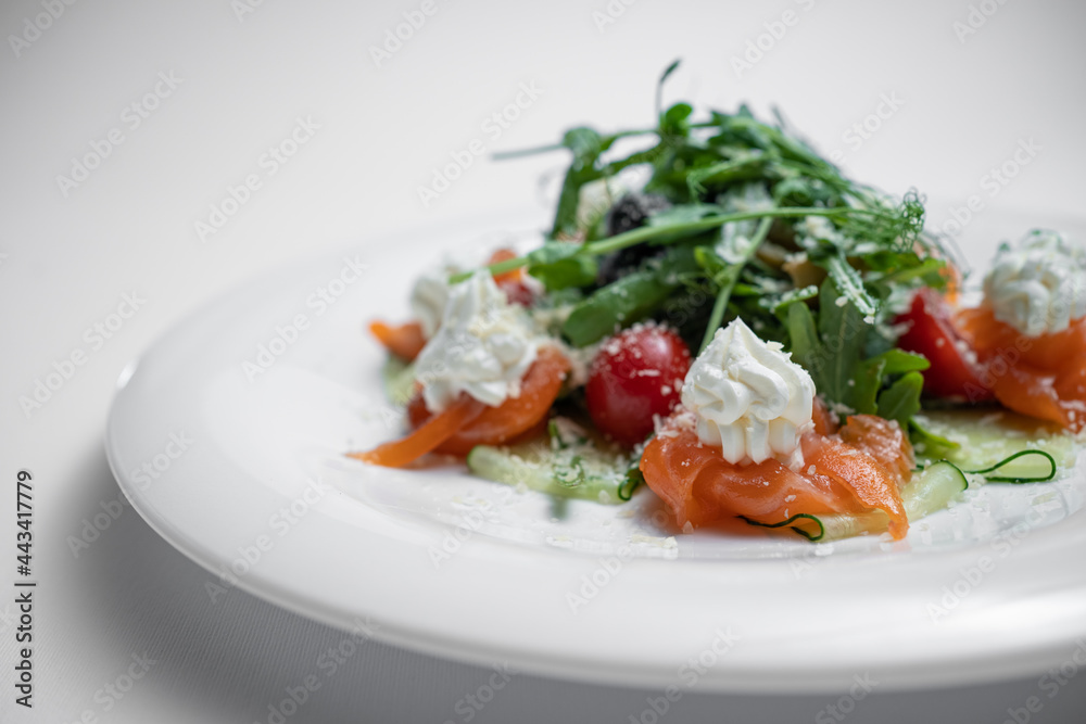 closeup of salad with salted salmon, cream cheese or arugula on white background closeup of salad with salted salmon, cream cheese or arugula on white background