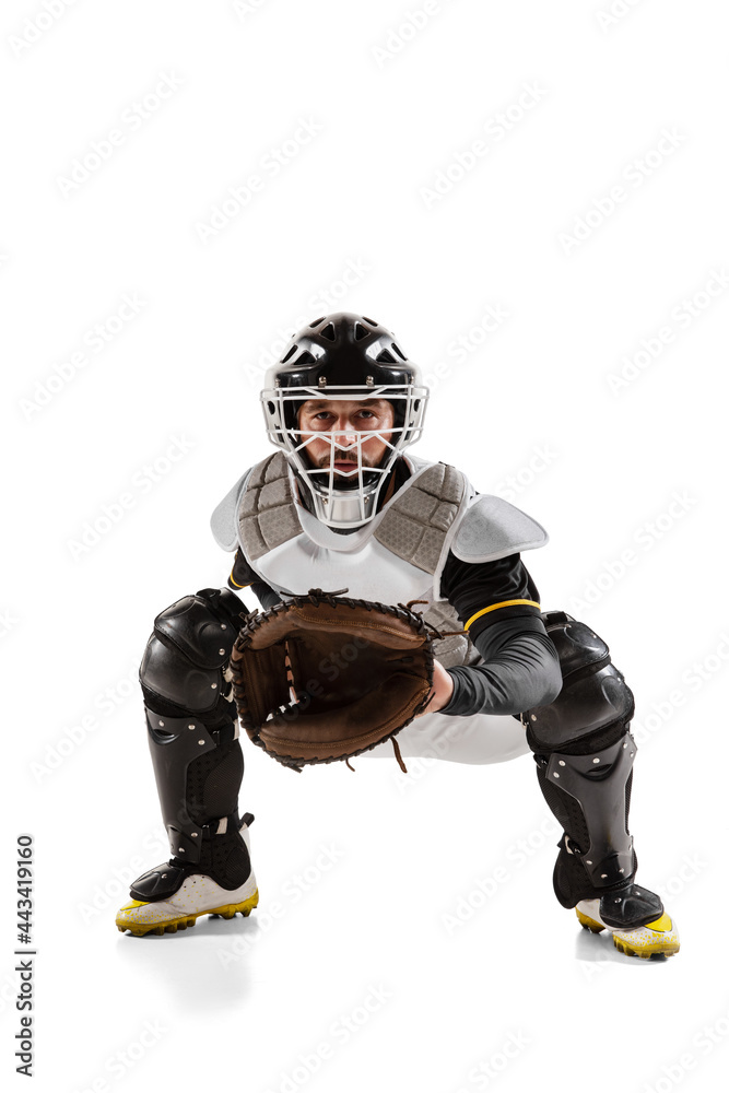 Baseball player, catcher in white sports uniform and equipment practicing isolated on a white studio background.