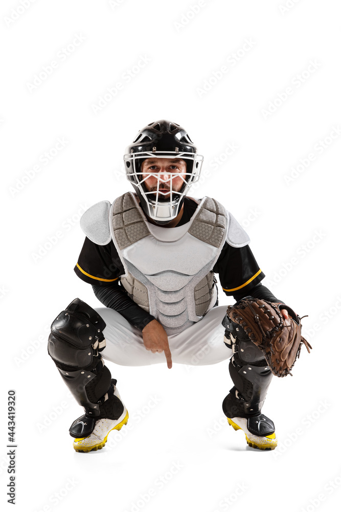 Baseball player, catcher in white sports uniform and equipment practicing isolated on a white studio background.