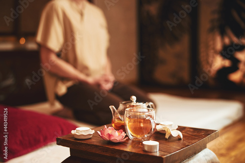 Man doing meditation during tea ceremony indoors