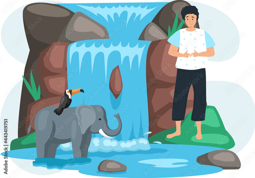 Guy looks at animals near waterfall in green forest. Toucan sits on  elephant on its back