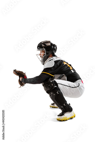 Baseball player, catcher in white sports uniform and equipment practicing isolated on a white studio background. Side view