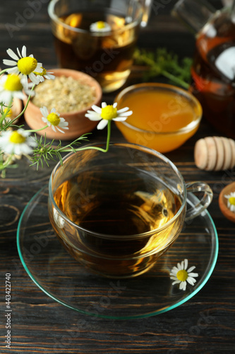 Concept of cooking chamomile tea on rustic wooden table