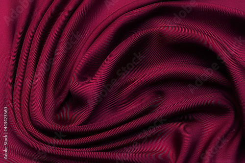 Cherry twill silk fabric in artistic layout. Texture, background, pattern.