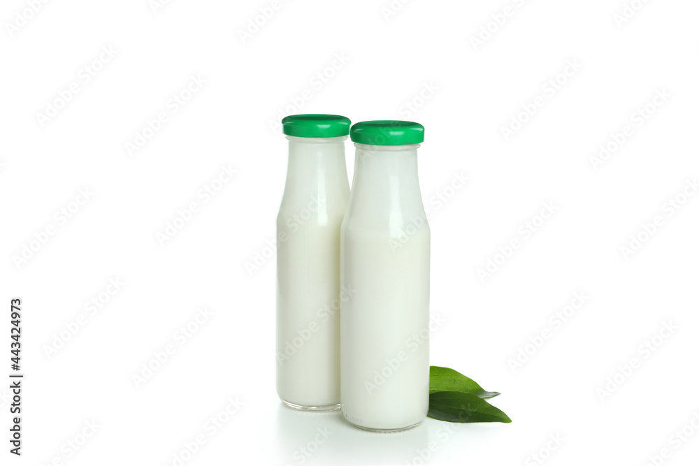 Bottles of milk and leaves isolated on white background Bottles of milk and leaves isolated on white background