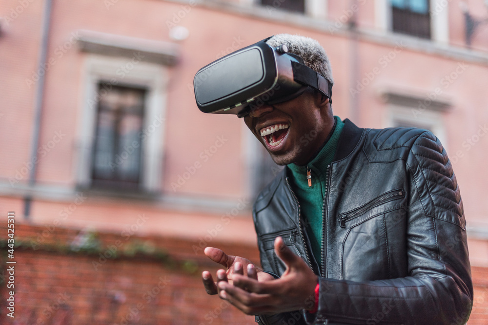Happy black man experiencing virtual reality in VR headset Happy black man experiencing virtual reality in VR headset