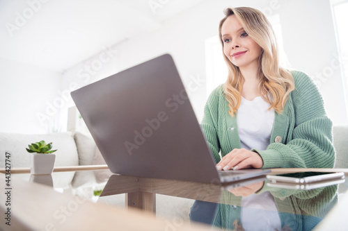 Photo of young attractive woman happy positive smile sit desk remote work browse laptop report self-isolation home