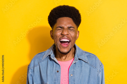 Photo of cheerful young afro american joyful man laugh good mood joke isolated on shine yellow color background