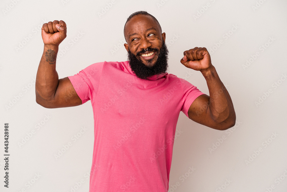 African american man with beard isolated on pink background celebrating a special day, jumps and raise arms with energy. African american man with beard isolated on pink background celebrating a special day, jumps and raise arms with energy.