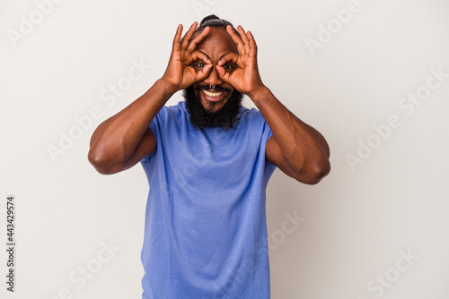 African american man with beard isolated on pink background excited keeping ok gesture on eye.