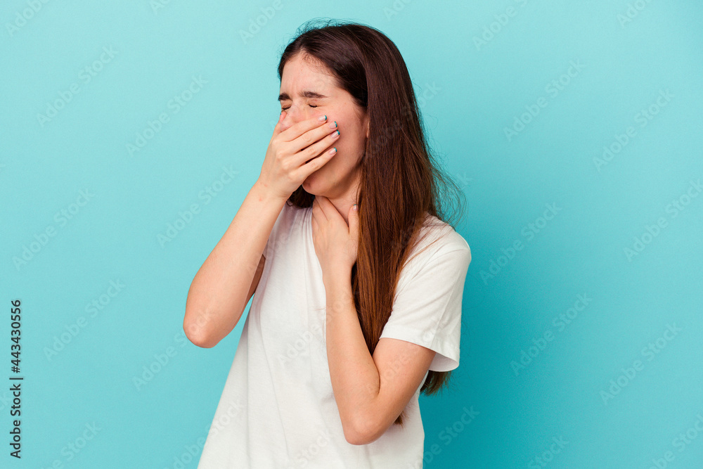 Young caucasian woman isolated on blue background suffers pain in throat due a virus or infection. Young caucasian woman isolated on blue background suffers pain in throat due a virus or infection.