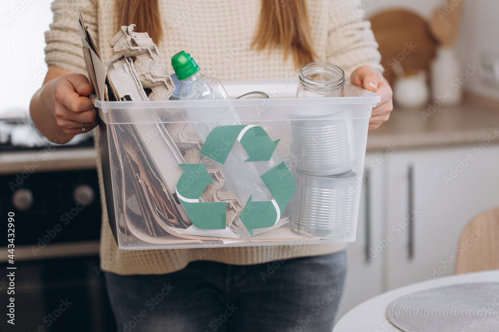 Fototapeta premium Woman sorting waste at home, storage and recycling concept.Zero waste