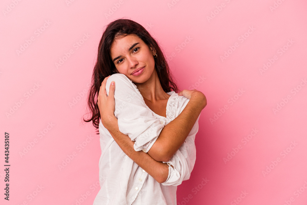 Young caucasian woman isolated on pink background hugs, smiling carefree and happy. Young caucasian woman isolated on pink background hugs, smiling carefree and happy.