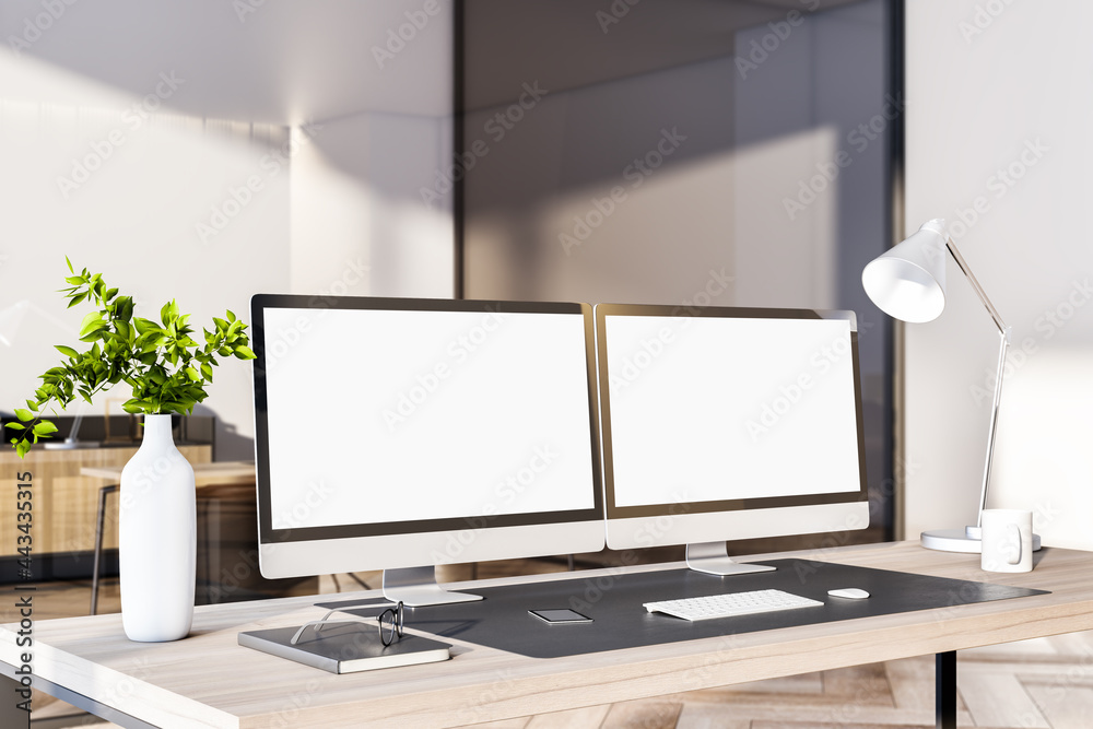 Fototapeta premium Modern office interior with desktop, empty white computer monitors and other items. Mock up, 3D Rendering.