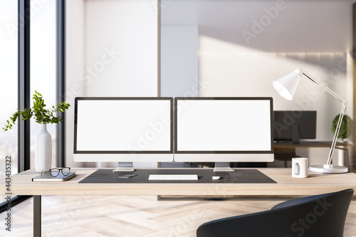 Two empty white computer screens on office desktop in interior with daytime city view. Corporate template. Mock up, 3D Rendering.