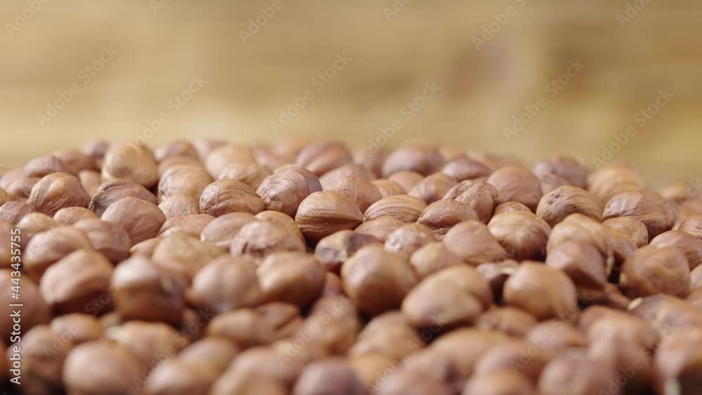 Macro shot of the rotating peeled hazelnuts. Dried brown hazel kernels close up. Organic healthy food background. Slow motion ready 59.94fps. Macro shot of the rotating peeled hazelnuts. Dried brown hazel kernels close up. Organic healthy food background. Slow motion ready 59.94fps.