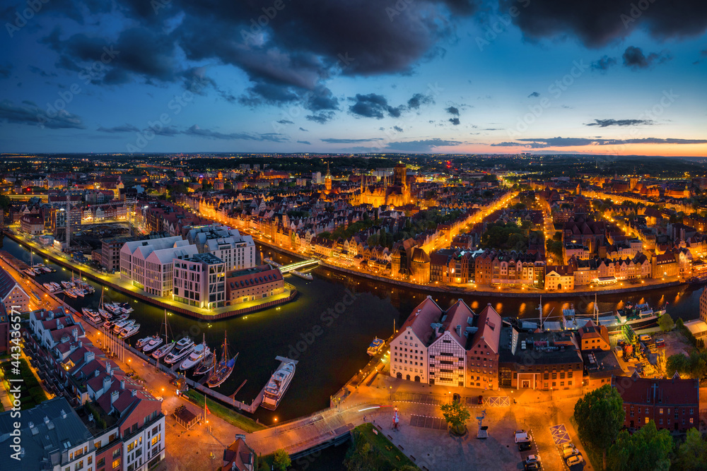 Amazing architecture of the main city in Gdansk at dusk, Poland. Aerial view of the historical Port Crane at the Motlawa river