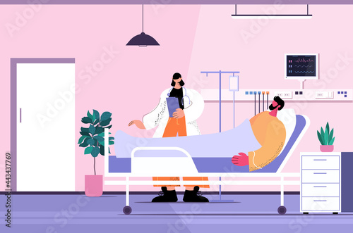 nurse taking care of sick man patient lying in hospital bed care service concept clinic ward interior