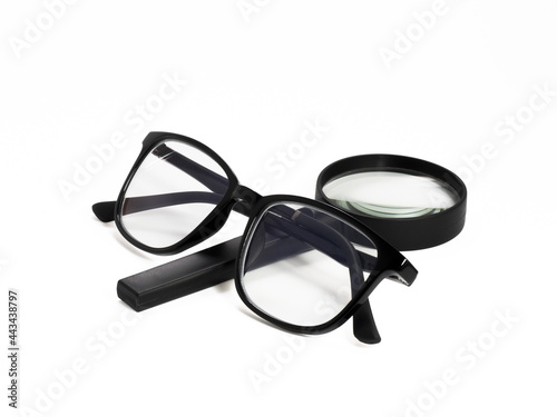 black glasses and magnifying glass isolated on white background. with clipping path.