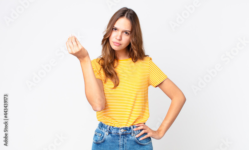 young pretty woman making capice or money gesture, telling you to pay photo