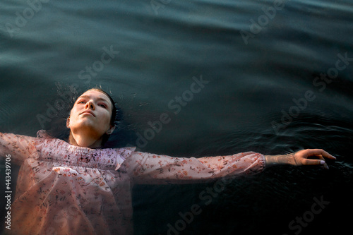 Girl in the water who is thinking about sence of life and her future. Freedom. Calming