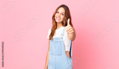 young pretty woman feeling proud,smiling positively with thumbs up photo