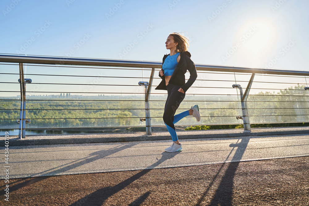 Motivated woman going running in open air