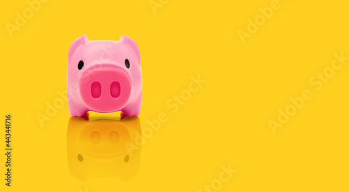 Saving Money Idea for Fund and retirement Concept, Pink piggy bank on yellow background