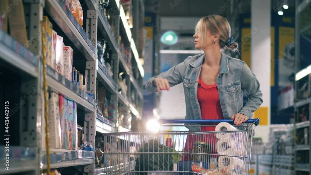 Supermarket with a woman choosing groceries to buy Supermarket with a woman choosing groceries to buy