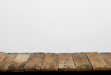 Empty wooden table top from rustic old wood planks, neutral gray background.