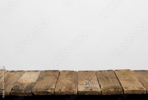 Empty wooden table top from rustic old wood planks, neutral gray background.